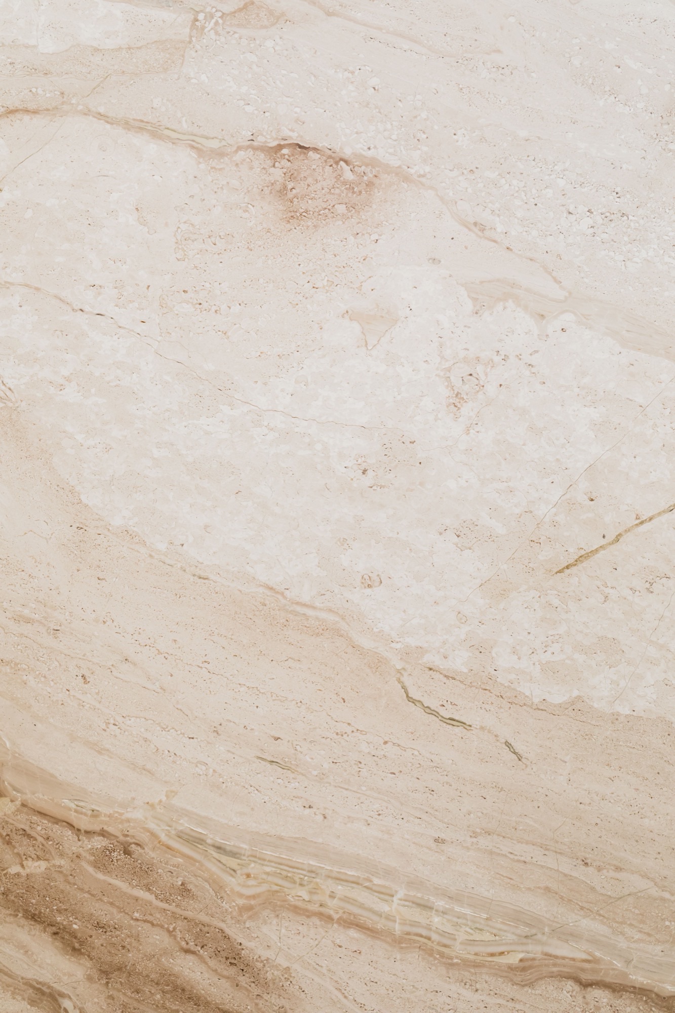 Cream granite close-up with warm veining and natural pits